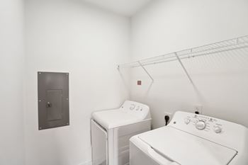 A white washing machine and dryer in a laundry room.